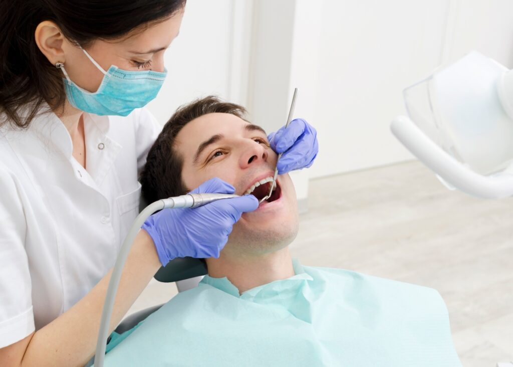 Cosmetic dentist in Palm Beach examining a patient's teeth 
