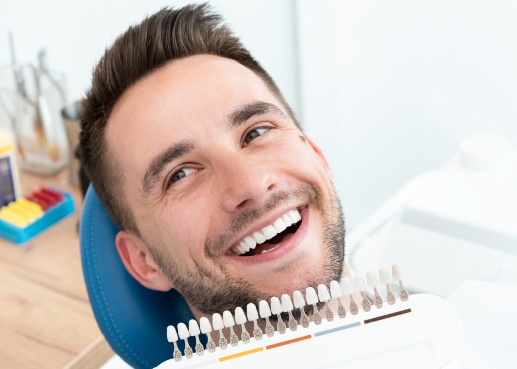 A confident man showcasing his radiant, clean smile, crafted by the experts at Palm Beach Dental Specialists.