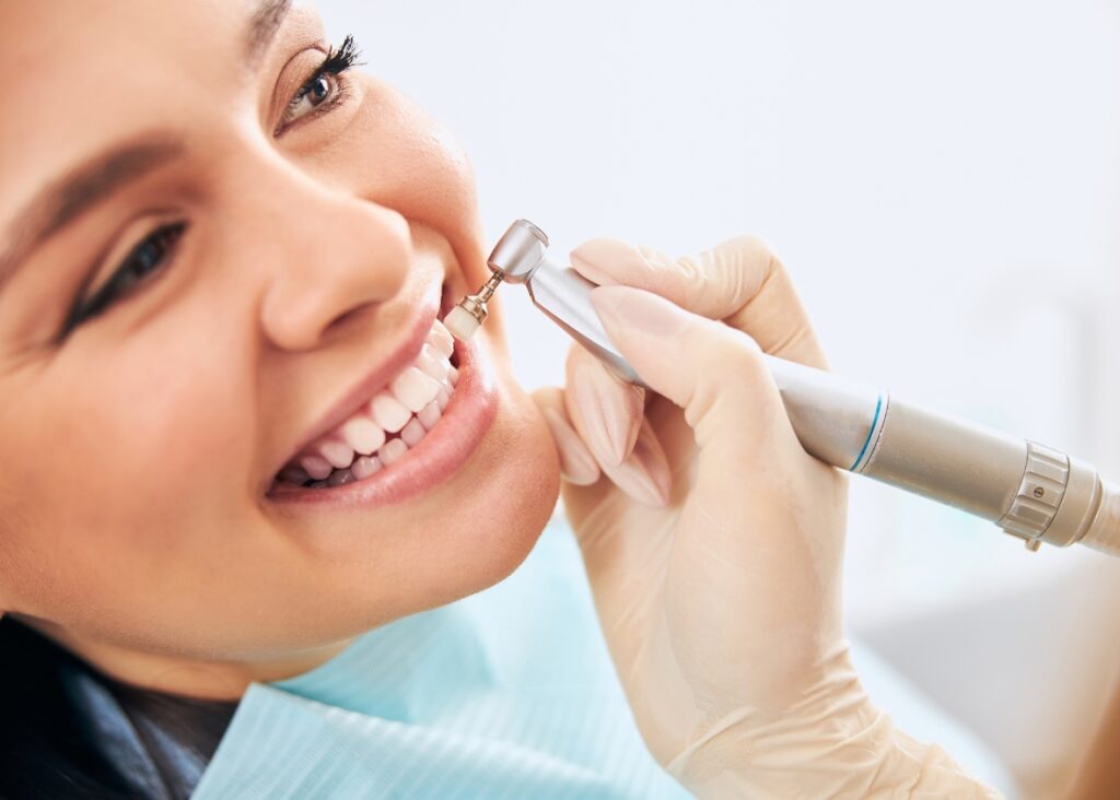 Dental specialist performing a thorough teeth cleaning procedure, ensuring optimal oral health and a bright smile.